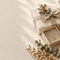 Wrapped gifts with a gold necklace and watch on cream linen