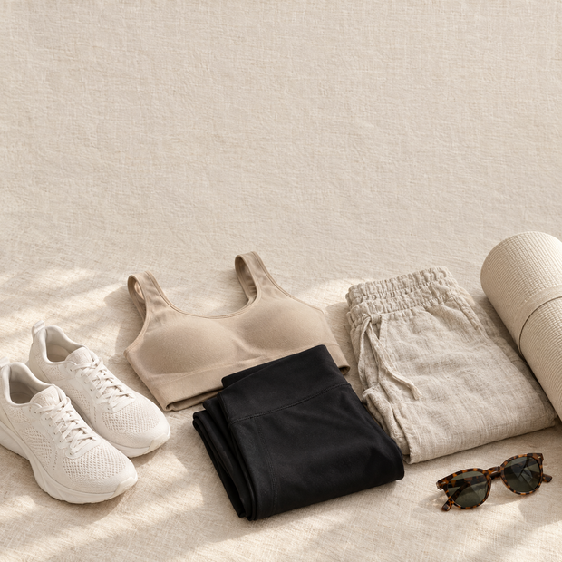Summer activewear and linen essentials on cream linen