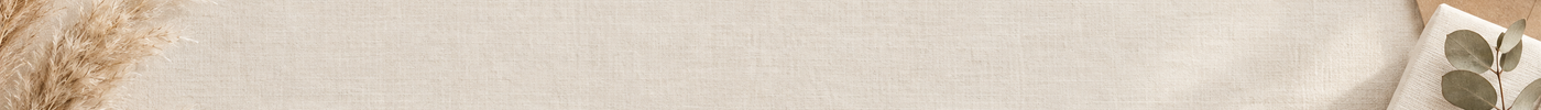 Cream linen background with a wrapped gift and envelope